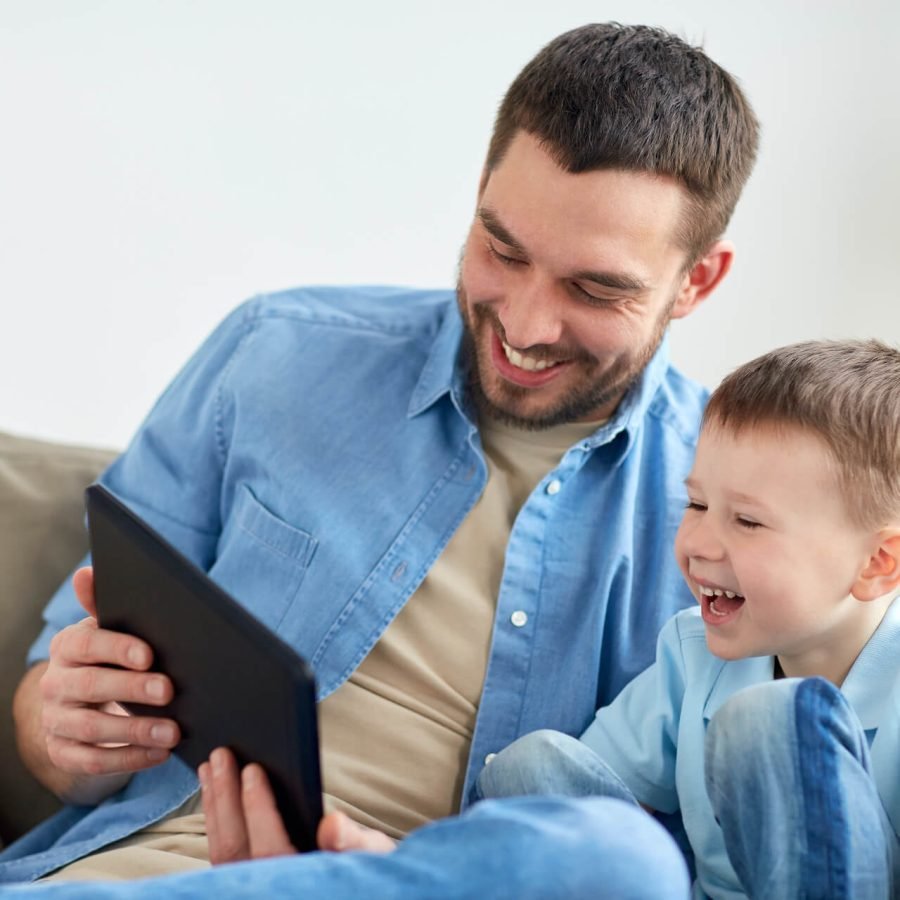 father-and-son-with-tablet-pc-playing-at-home-2024-09-28-03-46-16-utc.jpg